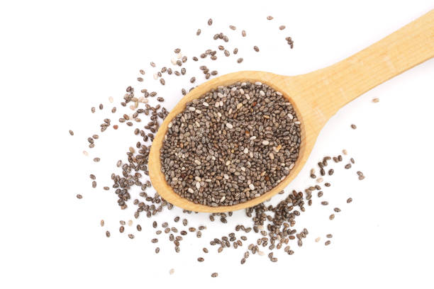 istock Chia seeds in wooden spoon isolated on white background. Top view 942425128