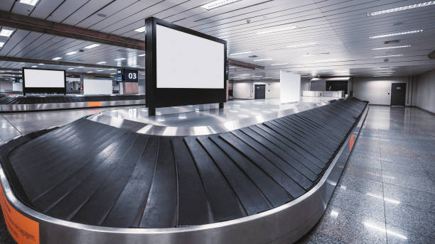 istock Conveyor belts with screens templates on them, airport terminal 942425606