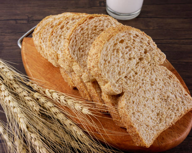 istock Whole wheat breads on wooden background 942428230