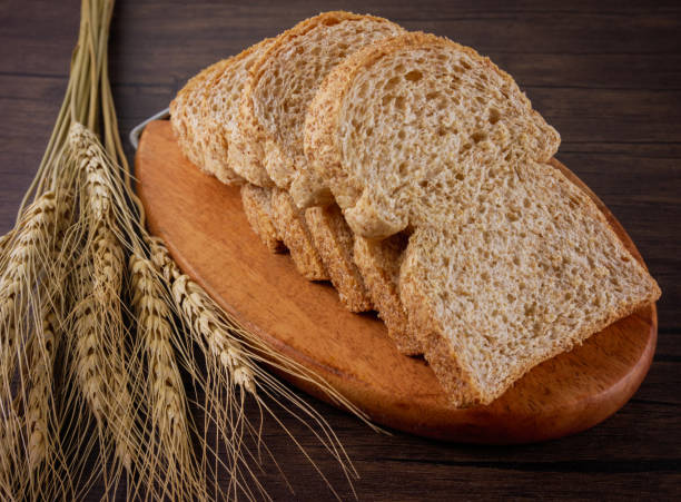 istock Whole wheat breads on wooden background 942428236