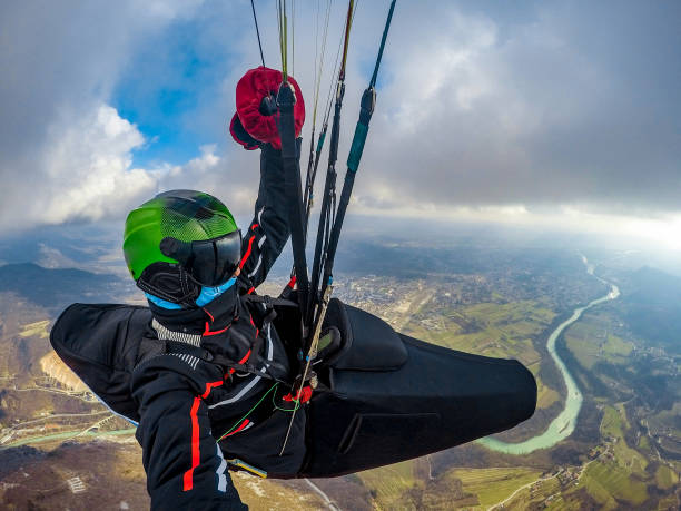 istock Adult Paraglider Enjoying Gliding on a Beautiful Day 942433582