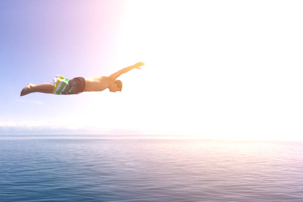 istock Man jump into the ocean 942434570