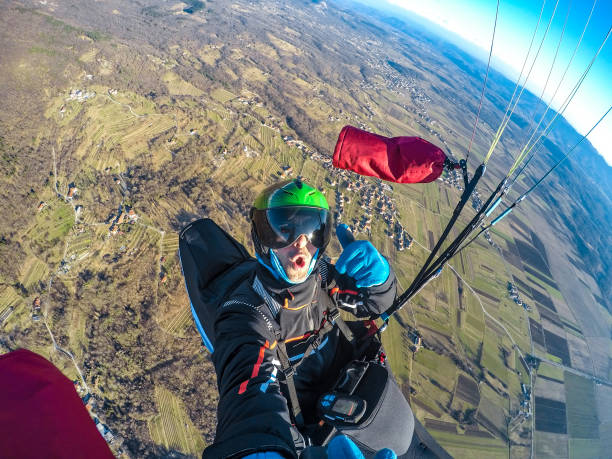 istock Adult Paraglider Taking a Selfie While Gliding 942436334