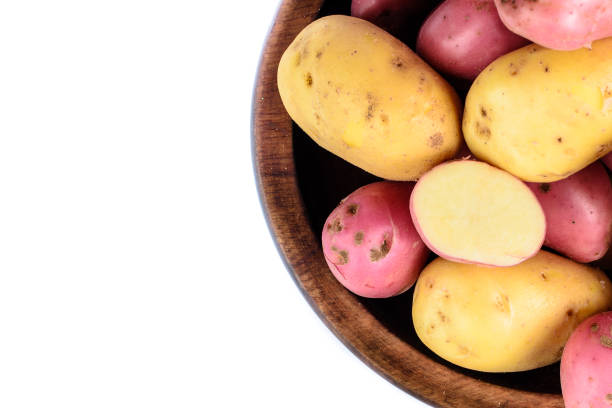 istock Raw potatoes in wooden bowl. 942436648