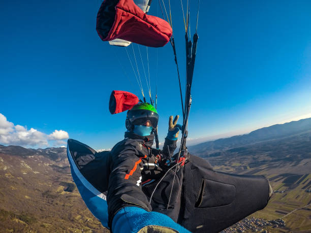 istock Adult Paraglider Taking a Selfie While Gliding 942436734