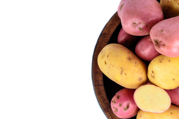 istock Raw potatoes in wooden bowl. 942436884