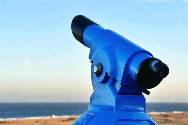 istock Binoculars - Telescope - on the beach - laterally from the left 942437082