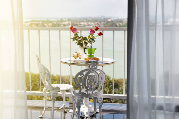 istock Breakfast with coffee on terrace decorated with flowers 942437110