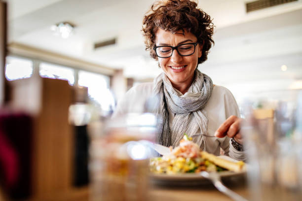 Woman having lunch at a restaurant Photo of woman having lunch at a restaurant ladies lunch stock pictures, royalty-free photos & images