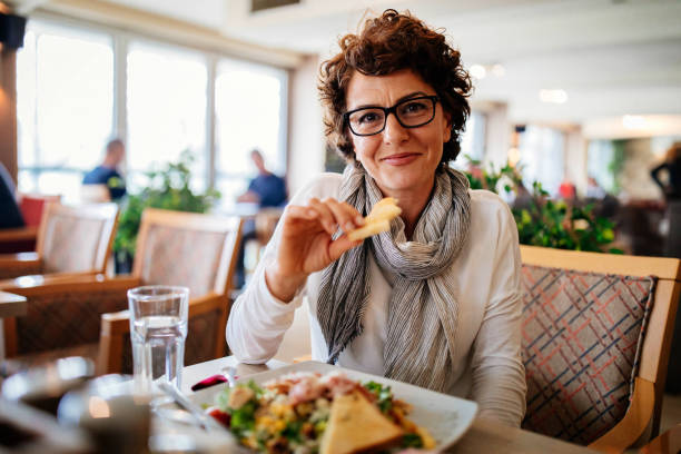 istock Woman having lunch at a restaurant 942437250
