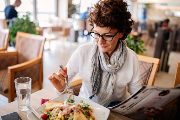 istock Woman having lunch at a restaurant 942439744