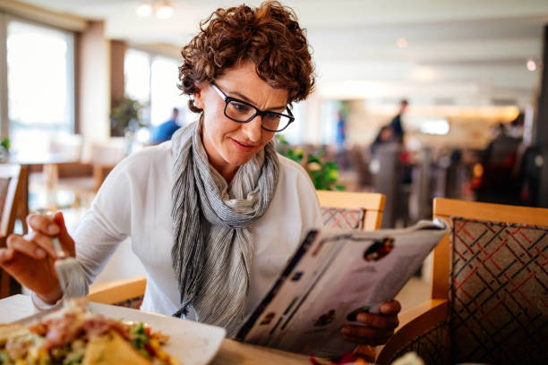 istock Woman having lunch at a restaurant 942439760