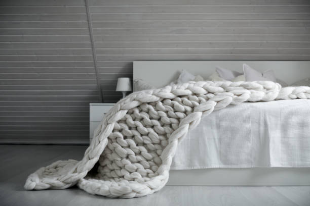 istock White nordic bedroom interior with knit plaid 942440158