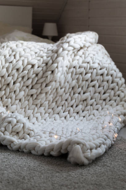 istock White scandinavian interior with knit plaid. 942440416