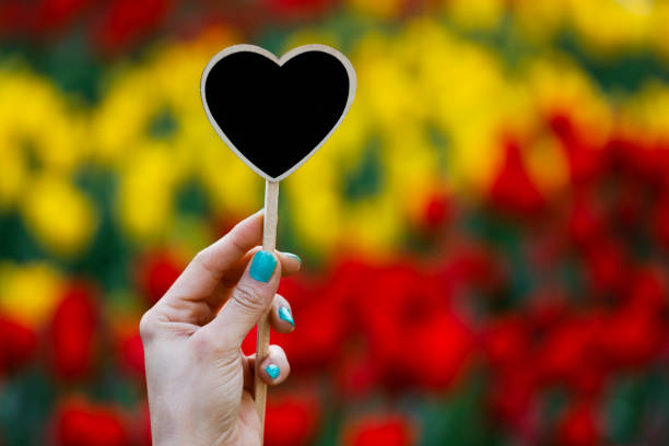 Woman holding black heart
