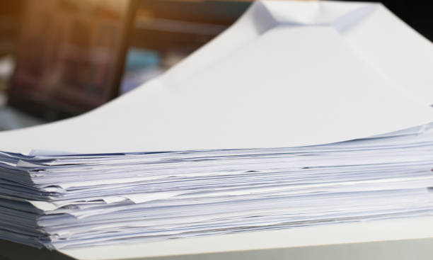 istock Stack white paper Document pile on office desk, Stack of business paper on table with blurred of meeting room background. Job busy business concepts. 942443174