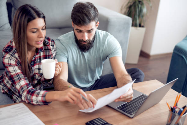 istock Young couple using laptop at home 942443438