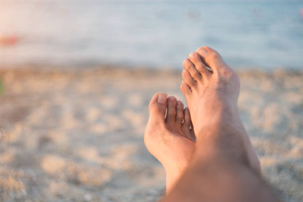 istock Male Feet at the Beach 942444964