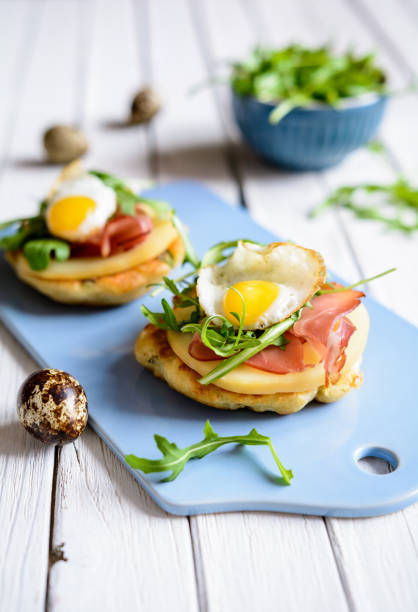 istock Savoury yoghurt and scallion pancakes with Black Forrest ham, smoked cheese, quail egg and arugula 942451682