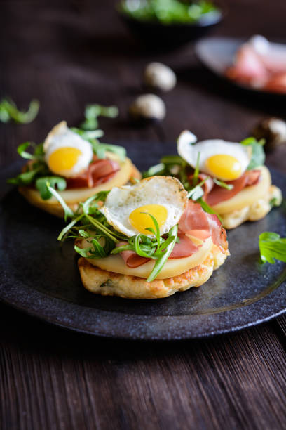 istock Savoury yoghurt and scallion pancakes with Black Forrest ham, smoked cheese, quail egg and arugula 942451684