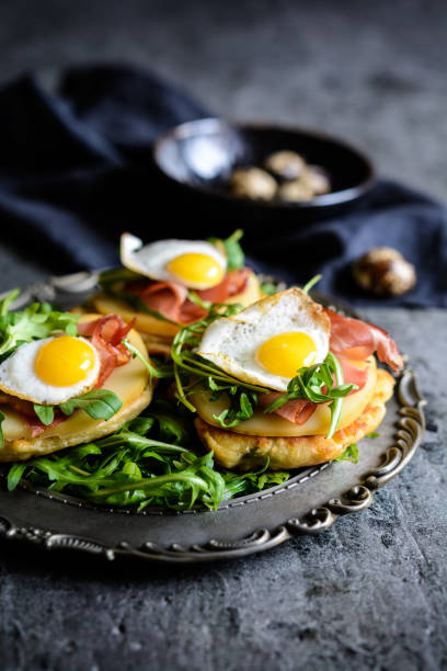 istock Savoury yoghurt and scallion pancakes with Black Forrest ham, smoked cheese, quail egg and arugula 942451694