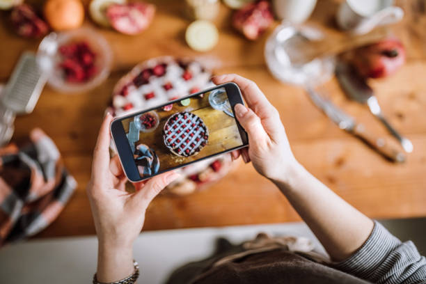 robienie zdjęć pyszne jagodowe ciasto ozdobione świeżymi malinami - blackberry telephone mobile phone smart phone zdjęcia i obrazy z banku zdjęć