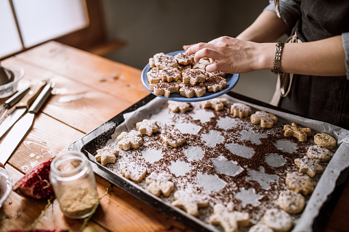 Woman Serving Fresh Baked Gingerbread Cookies With Sugar