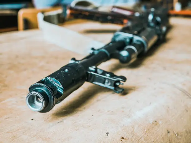 Photo of close up weapon muzzle on the table