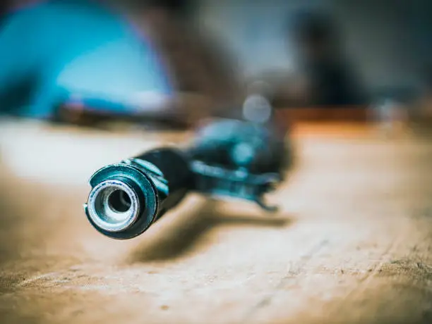 Photo of close up weapon muzzle on the table