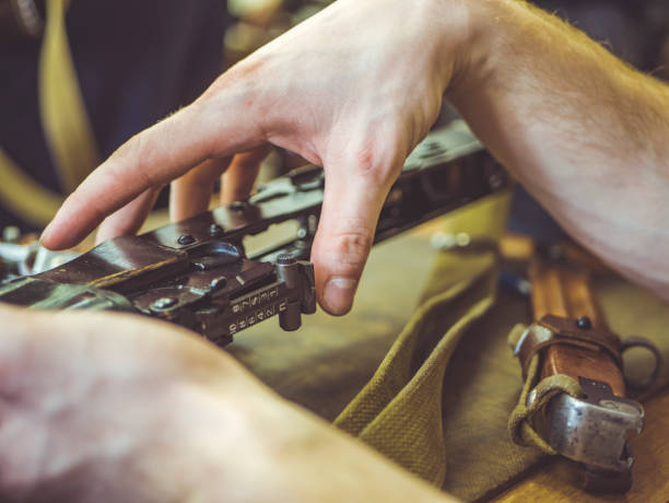 istock man disassemble rifle close up on the table 942456144