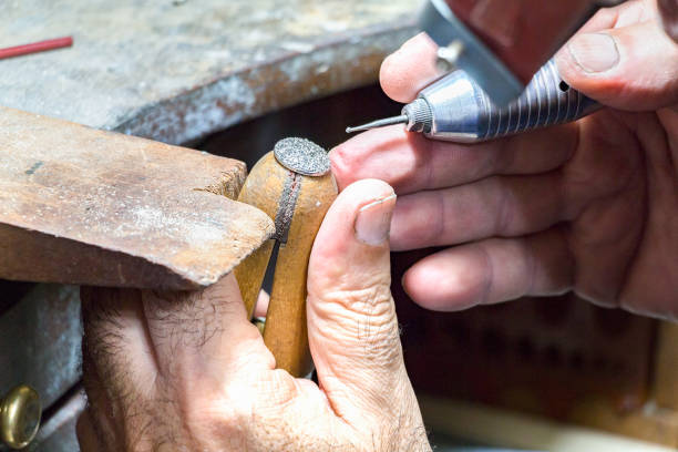 istock Jeweler engraving diamonds on a ring. 942456368