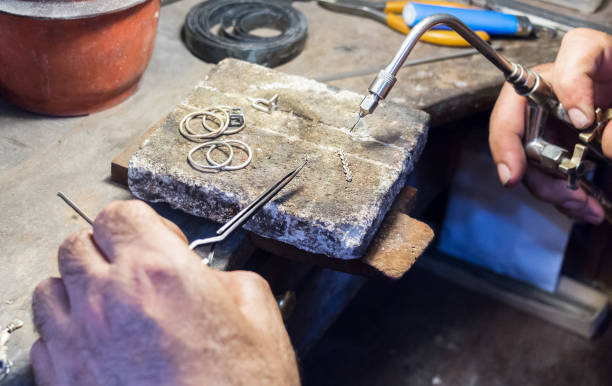 istock Jeweler using a gas - oxygen welding torch. 942456422