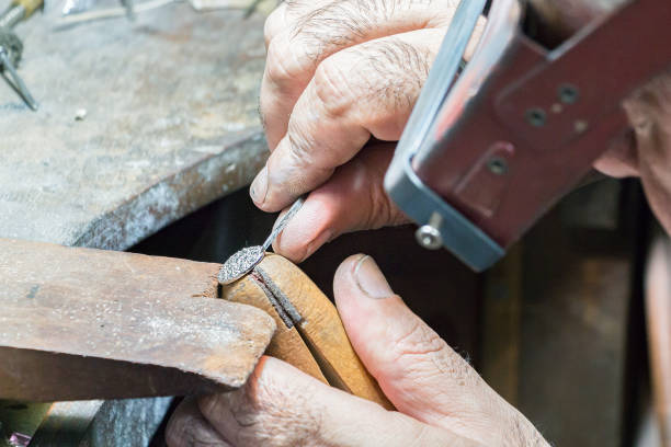istock Jeweler engraving diamonds on a ring. 942456524
