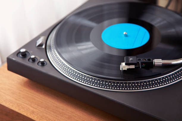istock Vintage Record Turntable Plays Black Vinyl Disk 942456648