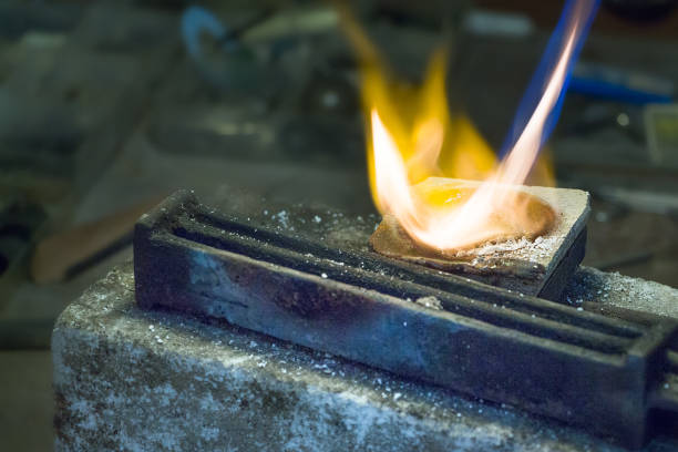 istock Jeweler melting silver on a ceramic pot. 942458742