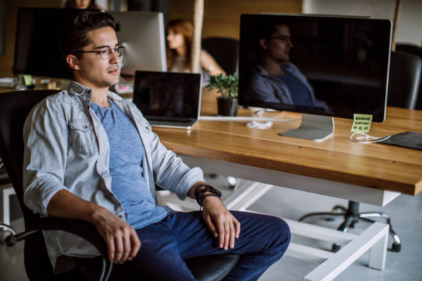 istock Mindful Young Man Sitting At The Office 942458776