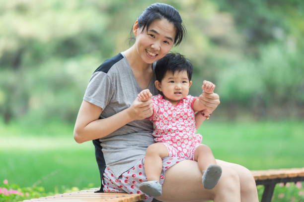istock Mother sitting and playing with her baby 942465870