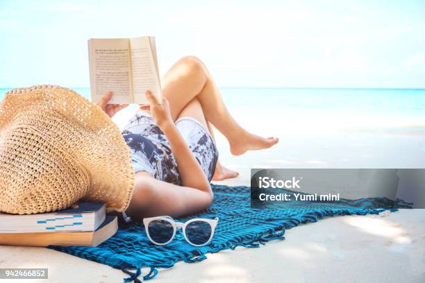 Woman Reading A Book On The Beach In Free Time Summer Holiday Stock Photo - Download Image Now
