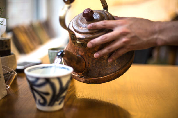 istock kettle pouring boiling water into a cup in cafe 942473580