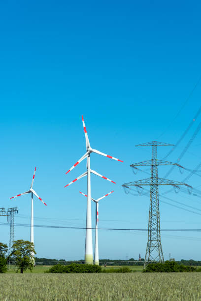 istock Overhead lines and wind engines on a sunny day 942487142
