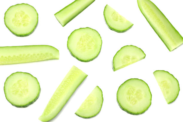 istock fresh cucumber slices isolated on white background. top view 942502896