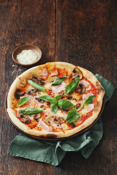 istock Pizza with ham, mozzarella, mushrooms, herbs 942505870