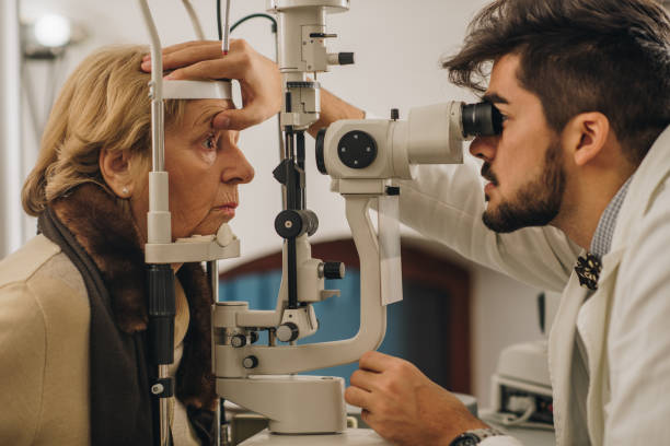 istock Old woman having an eye exam at ophthalmologist's office. 942510474