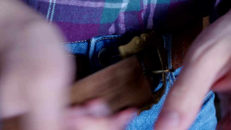 fastening the belt on trousers, decorative buckle