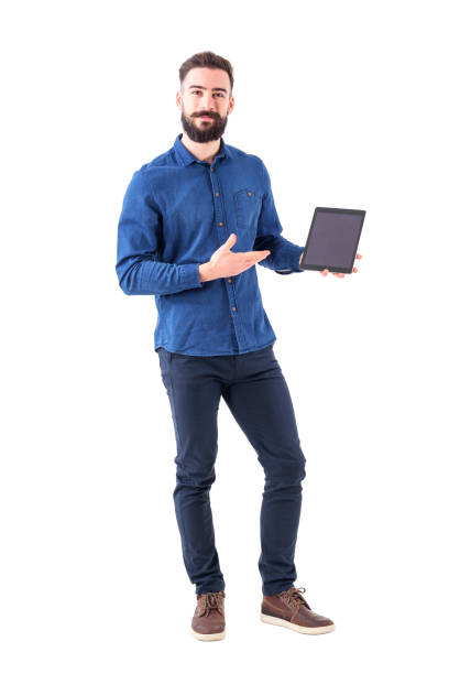 Happy smiling smart casual business man holding and showing blank touch pad screen looking at camera stock photo