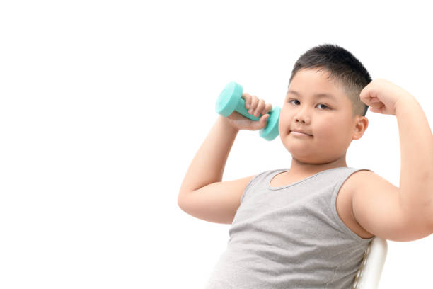 istock Overweight boy holding dumbbell isolated 942515896