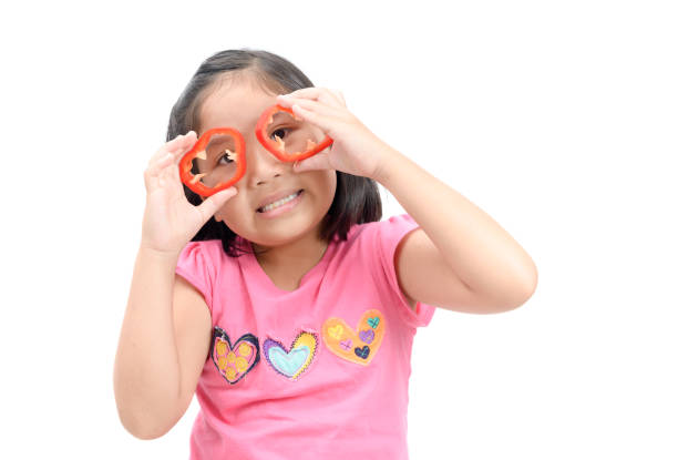 istock kid girl having fun with food vegetables 942515980