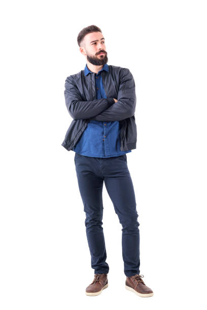 istock Cool skeptical bearded young man with crossed arms looking away. 942516012