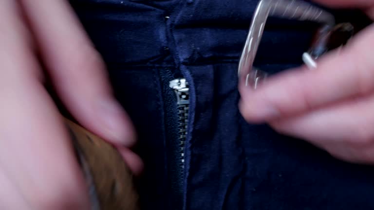 fastening the belt on trousers, fly, slit