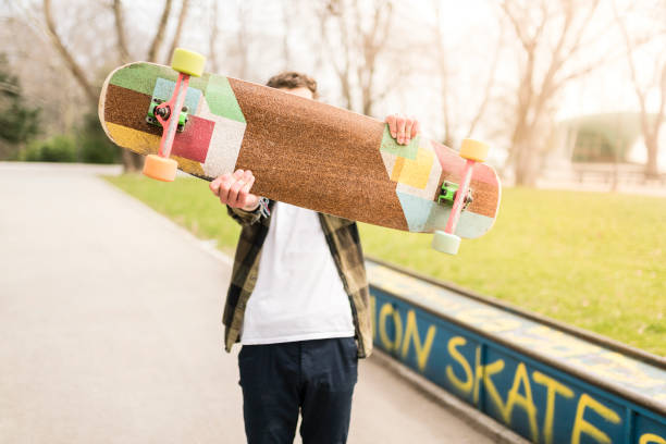 teenager holding his skateboard in front - skateboard park ramp skateboard graffiti imagens e fotografias de stock